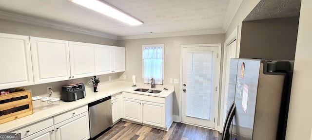 kitchen featuring dark wood-type flooring, sink, crown molding, stainless steel dishwasher, and white cabinetry