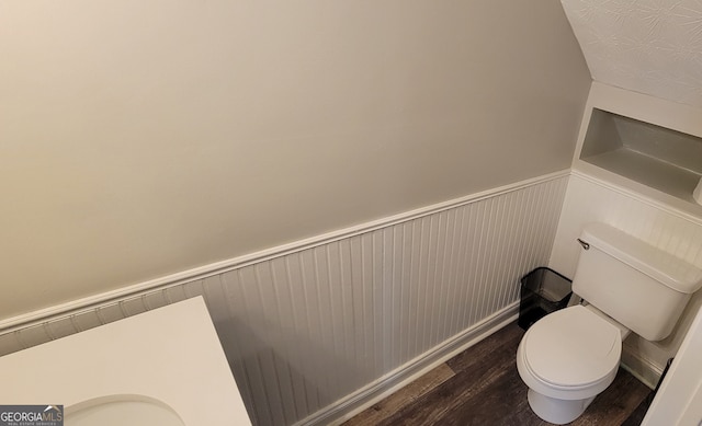 bathroom featuring hardwood / wood-style flooring and toilet