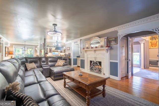 living room featuring light hardwood / wood-style flooring and ornamental molding