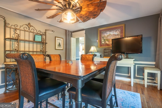 dining space featuring dark wood-type flooring and ceiling fan