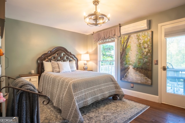 bedroom with dark wood-type flooring, a wall mounted AC, and an inviting chandelier