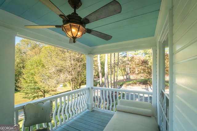 wooden terrace featuring ceiling fan