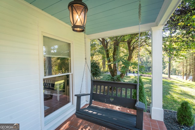 deck with a lawn and a porch