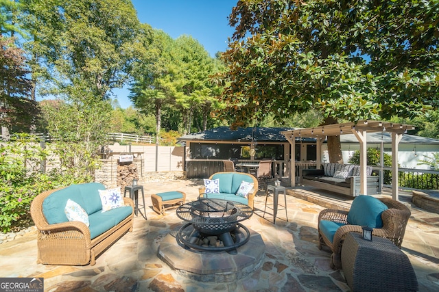 view of patio featuring an outdoor living space with a fire pit and a pergola