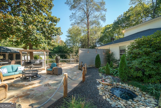 view of patio / terrace with an outdoor living space with a fire pit