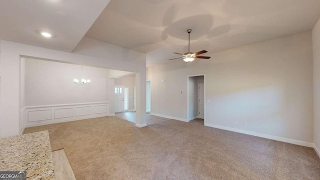 unfurnished living room with light carpet and ceiling fan with notable chandelier