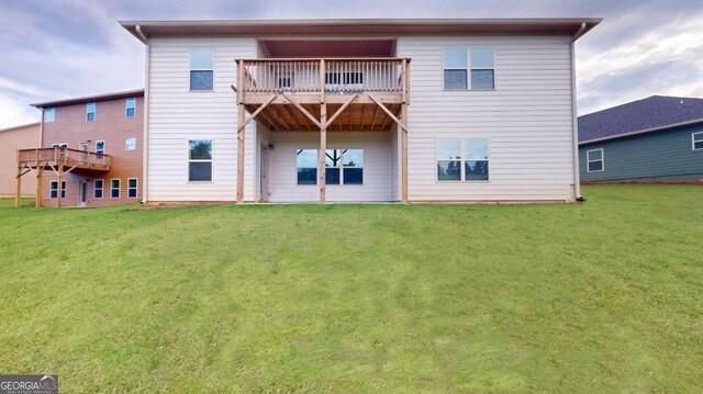 rear view of house with a balcony and a yard