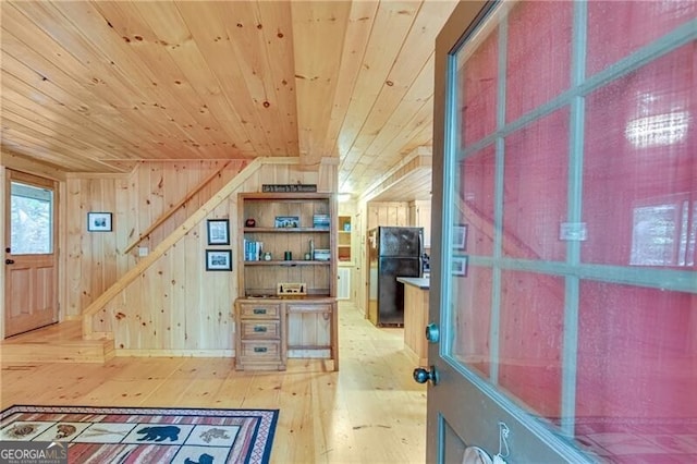 additional living space with wood ceiling, wood walls, and wood-type flooring