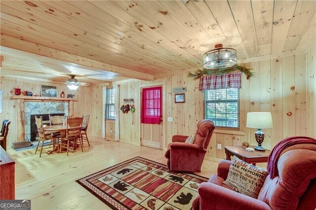 living room featuring wood walls, hardwood / wood-style flooring, and a wealth of natural light