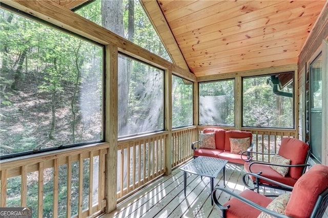 sunroom / solarium with vaulted ceiling, wooden ceiling, and plenty of natural light