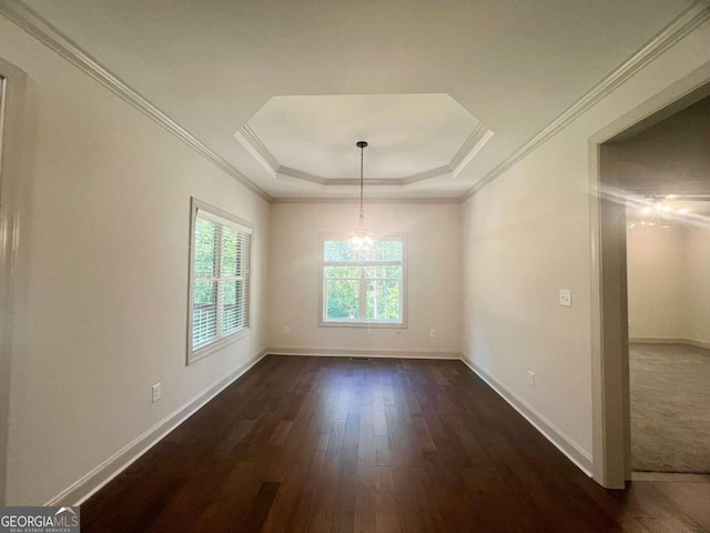 unfurnished dining area with an inviting chandelier, ornamental molding, dark wood-type flooring, and a raised ceiling