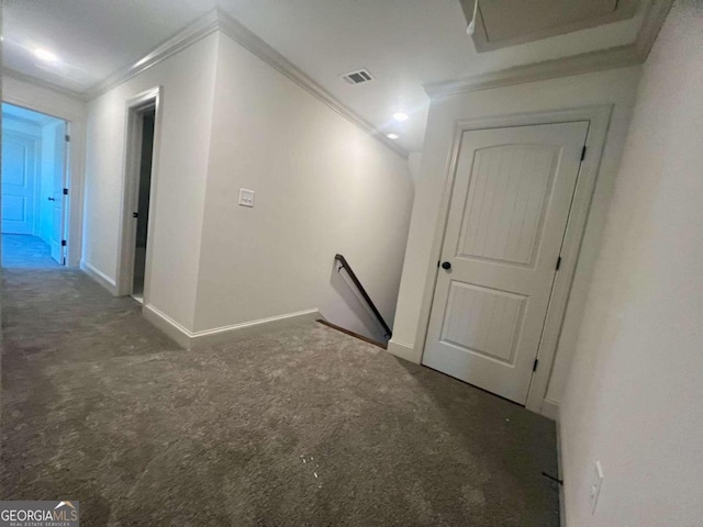 corridor featuring crown molding and dark colored carpet