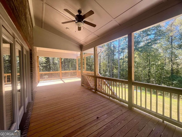 wooden terrace with a yard and ceiling fan