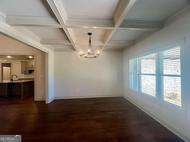 unfurnished dining area with beam ceiling, a notable chandelier, and dark hardwood / wood-style flooring