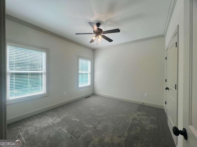 unfurnished room with ceiling fan, ornamental molding, and dark colored carpet