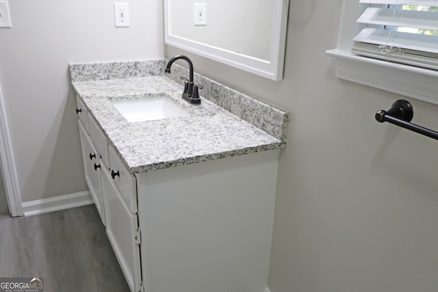 bathroom featuring vanity and hardwood / wood-style flooring