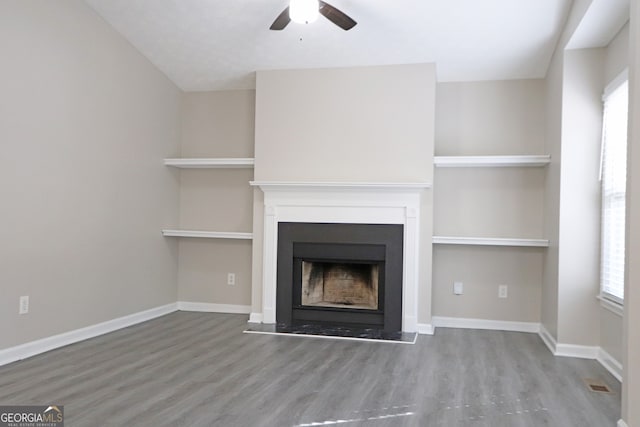 unfurnished living room with hardwood / wood-style floors and ceiling fan