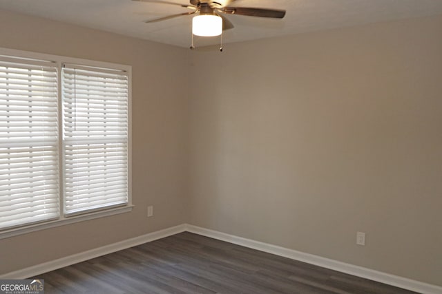 unfurnished room featuring ceiling fan and dark hardwood / wood-style floors