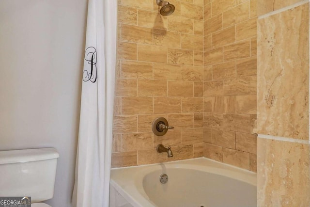 bathroom featuring shower / bath combination with curtain and toilet