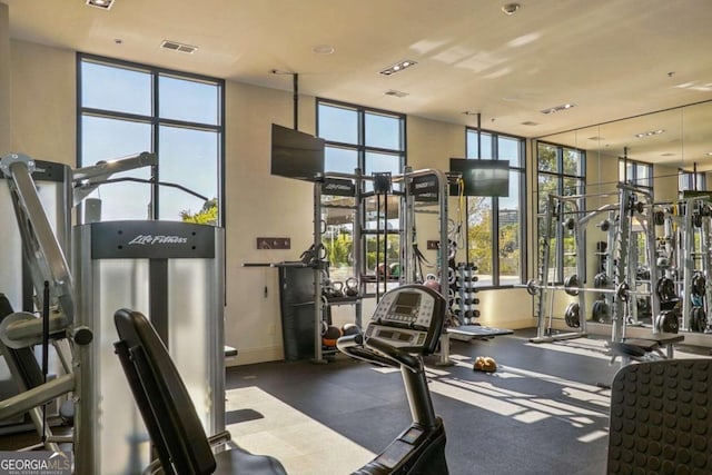 gym with a wall of windows