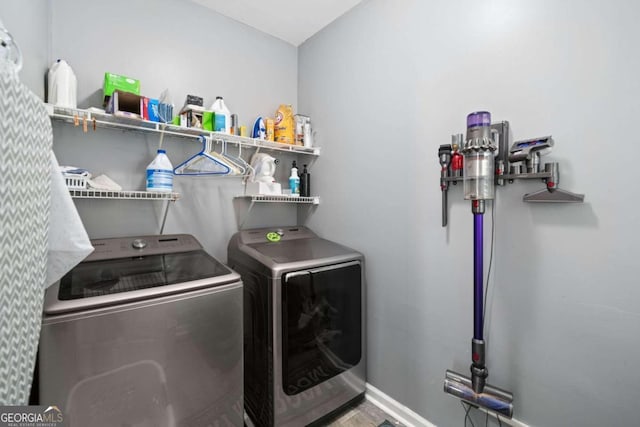 laundry area featuring hardwood / wood-style flooring and washing machine and dryer