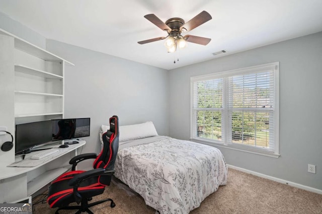 bedroom with ceiling fan and light carpet