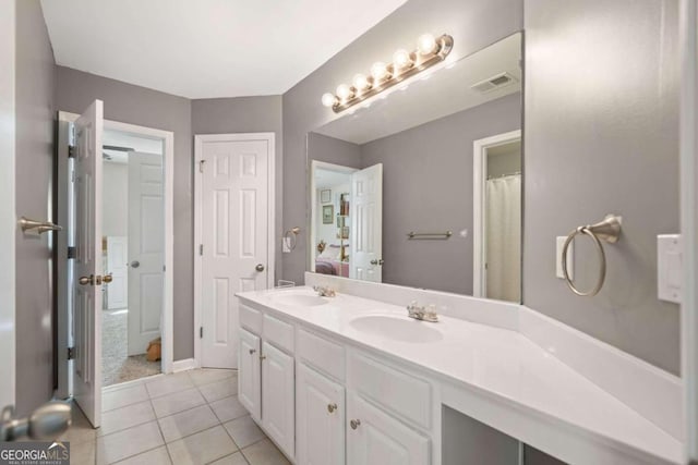 bathroom with vanity, a shower with shower curtain, and tile patterned flooring