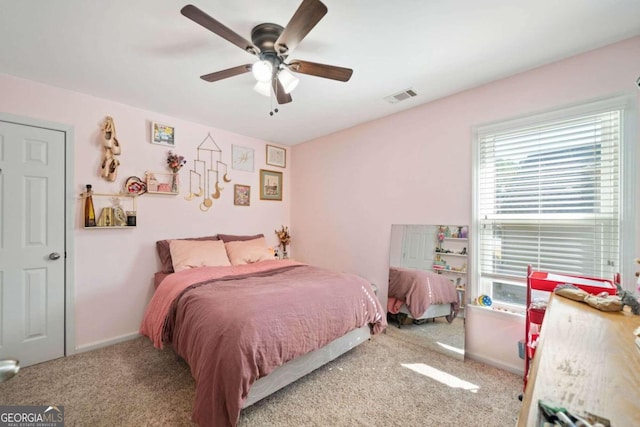 bedroom with ceiling fan and light carpet