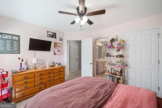 carpeted bedroom featuring ensuite bathroom and ceiling fan