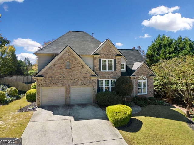 view of property with a front lawn and a garage