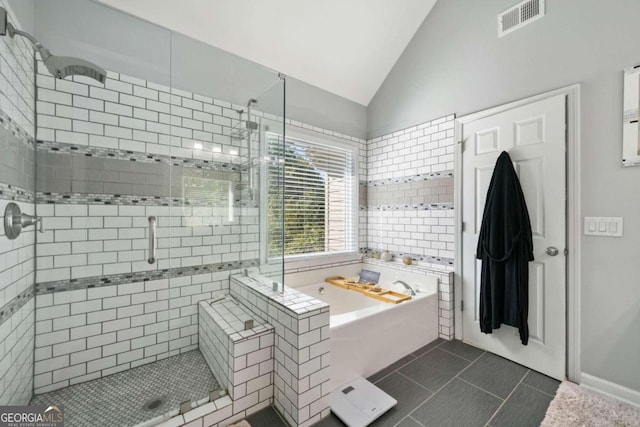 bathroom with lofted ceiling, tile patterned floors, and separate shower and tub