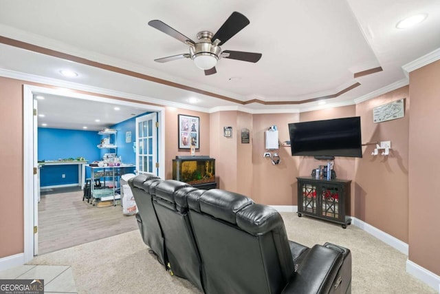 carpeted living room with ornamental molding and ceiling fan