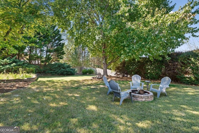 view of yard featuring an outdoor fire pit