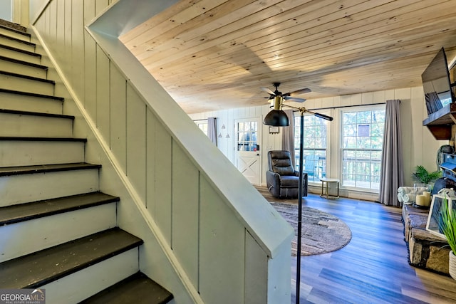 stairway featuring hardwood / wood-style floors, wooden ceiling, and ceiling fan