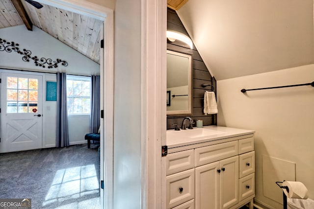 bathroom featuring vanity and vaulted ceiling with beams