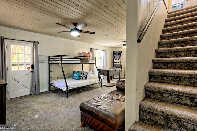 bedroom featuring wood ceiling, carpet flooring, and ceiling fan