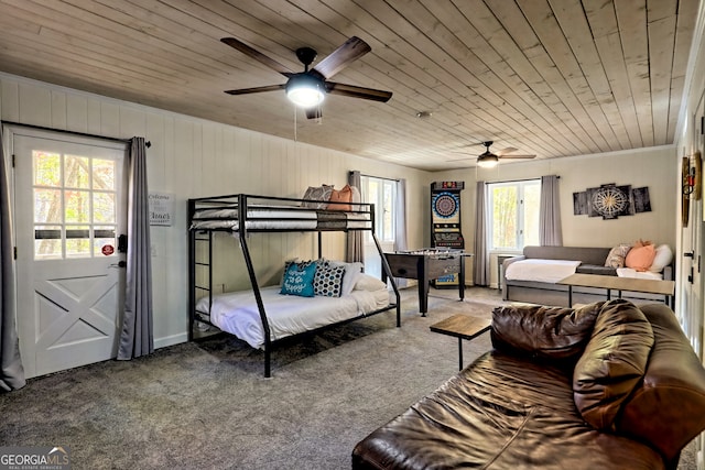 carpeted bedroom featuring ceiling fan, multiple windows, and wooden ceiling