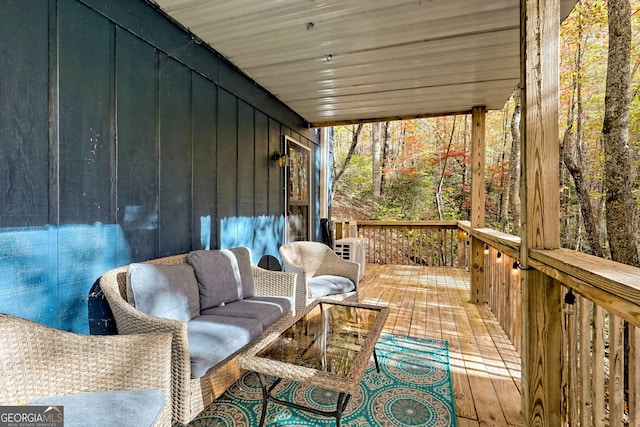 wooden terrace featuring outdoor lounge area