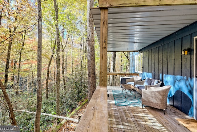 view of patio / terrace featuring a wooden deck and an outdoor living space