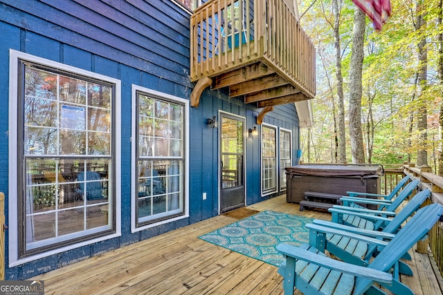 wooden terrace featuring a hot tub