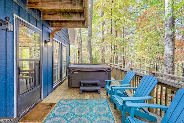 wooden deck with a hot tub