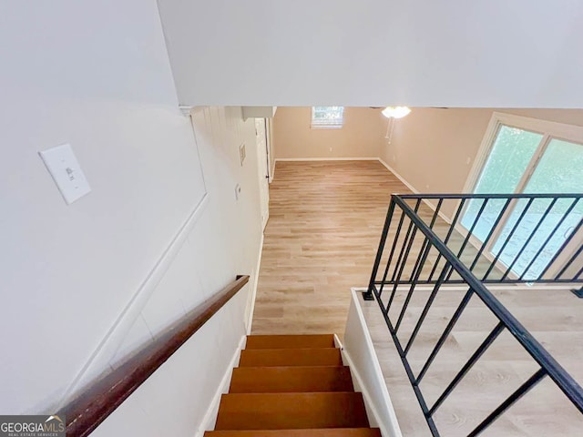 stairs featuring wood-type flooring