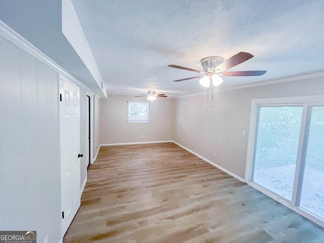 empty room featuring ceiling fan, ornamental molding, and light hardwood / wood-style flooring