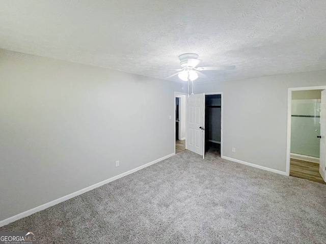 unfurnished bedroom featuring carpet floors, a textured ceiling, and ceiling fan