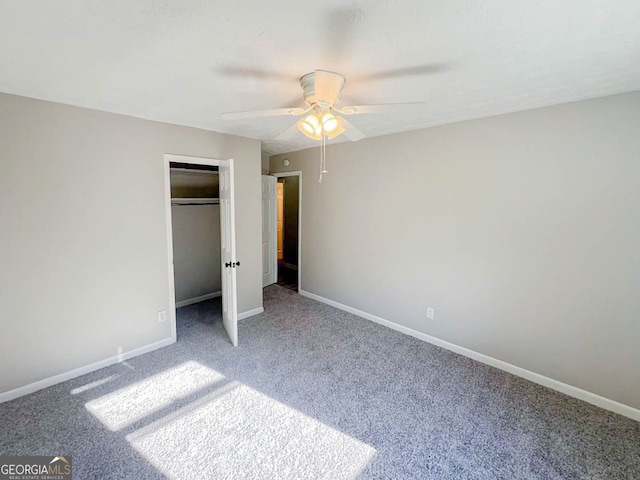 unfurnished bedroom featuring carpet flooring, a closet, and ceiling fan