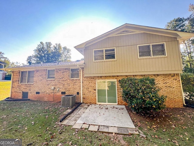 rear view of house featuring cooling unit, a patio area, and a lawn