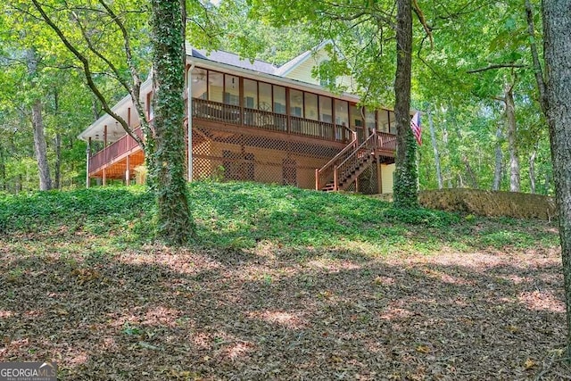 rear view of property with a wooden deck