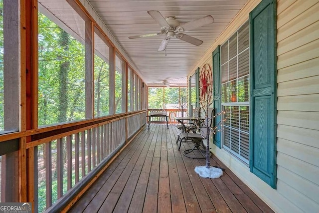 unfurnished sunroom with wood ceiling, plenty of natural light, and ceiling fan