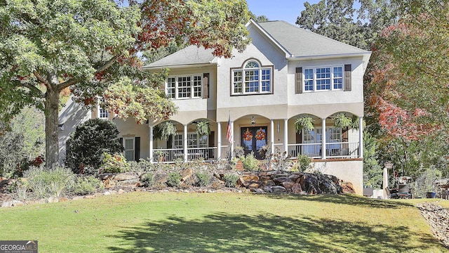 view of front of house featuring a front yard, french doors, and a porch