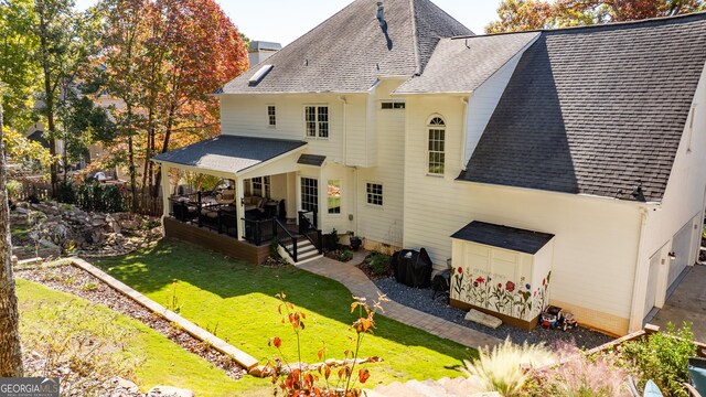 rear view of house with a lawn